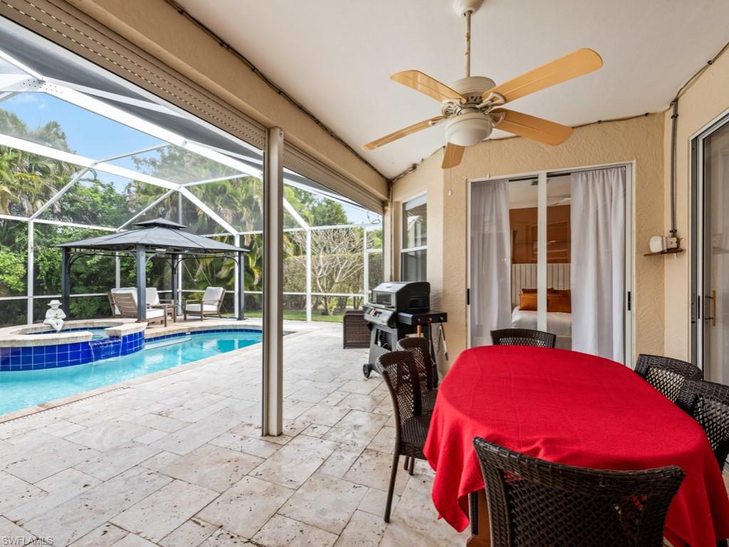 127 Palmetto Dunes Circle Naples, FL 34113 - Photo 18 of 20 a view of a hall with a dining table and chairs