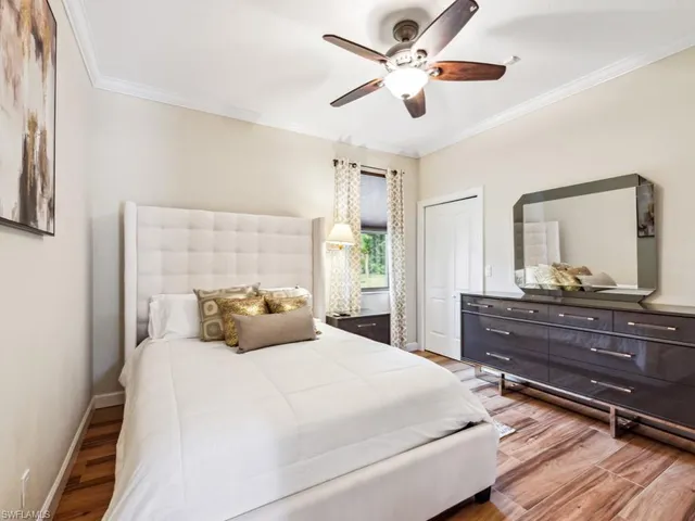 a bedroom with a large bed and a large mirror