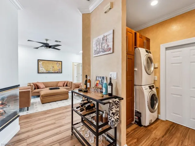 a view of a livingroom with furniture a flat screen tv and wooden floor