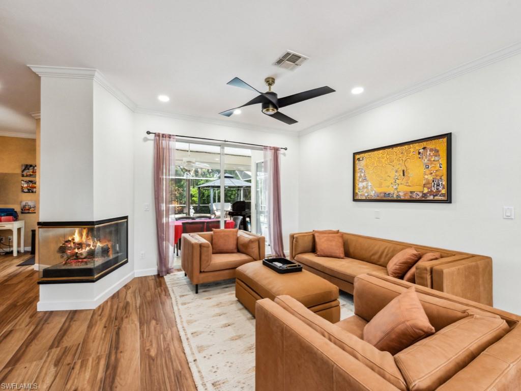127 Palmetto Dunes Circle Naples, FL 34113 - Photo 10 of 20 a living room with furniture and a fireplace