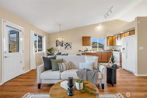 a living room with furniture and kitchen view