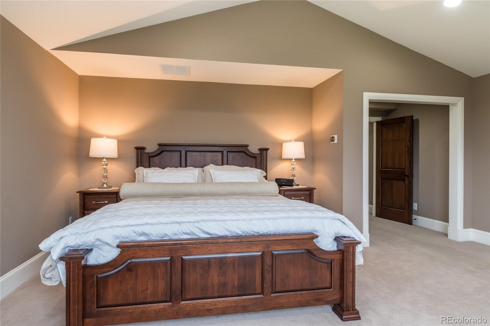 4624 Sunnyside Place Boulder, CO 80301 - Photo 22 of 40 a bedroom with a bed and a mirror