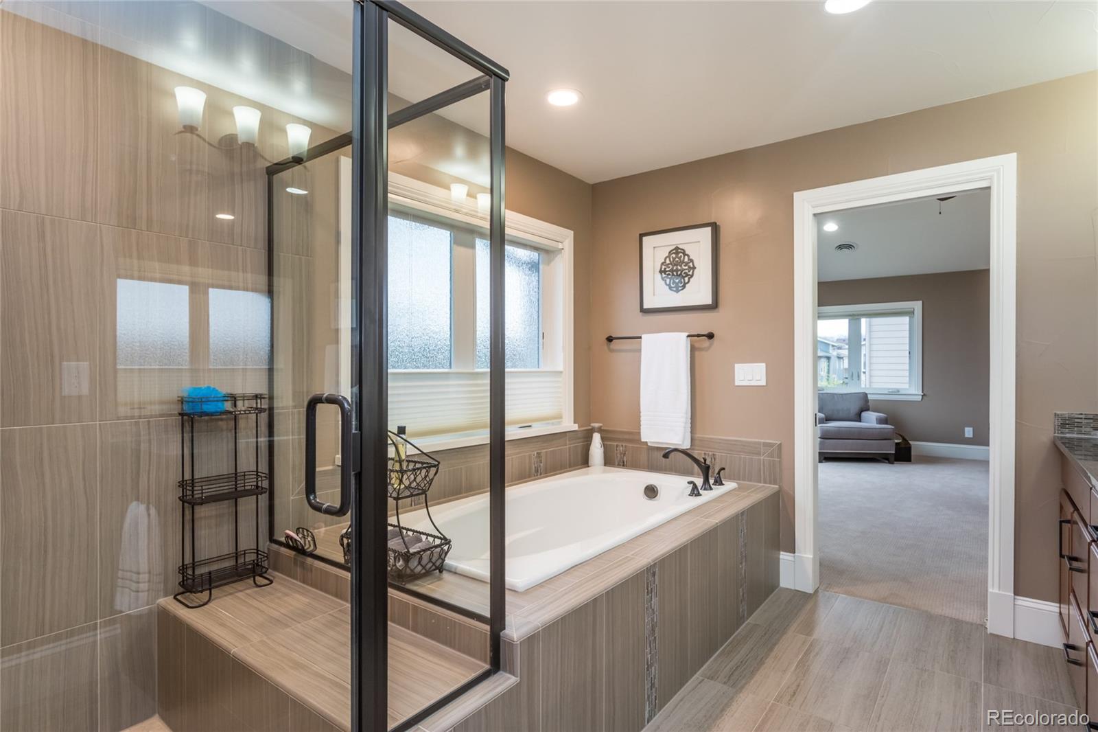 4624 Sunnyside Place Boulder, CO 80301 - Photo 27 of 40 a spacious bathroom with a tub shower and mirror