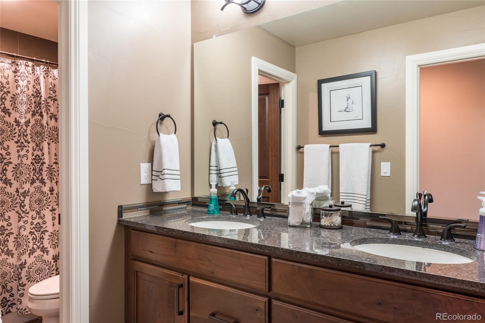 4624 Sunnyside Place Boulder, CO 80301 - Photo 30 of 40 a bathroom with double vanity sinks and a mirror