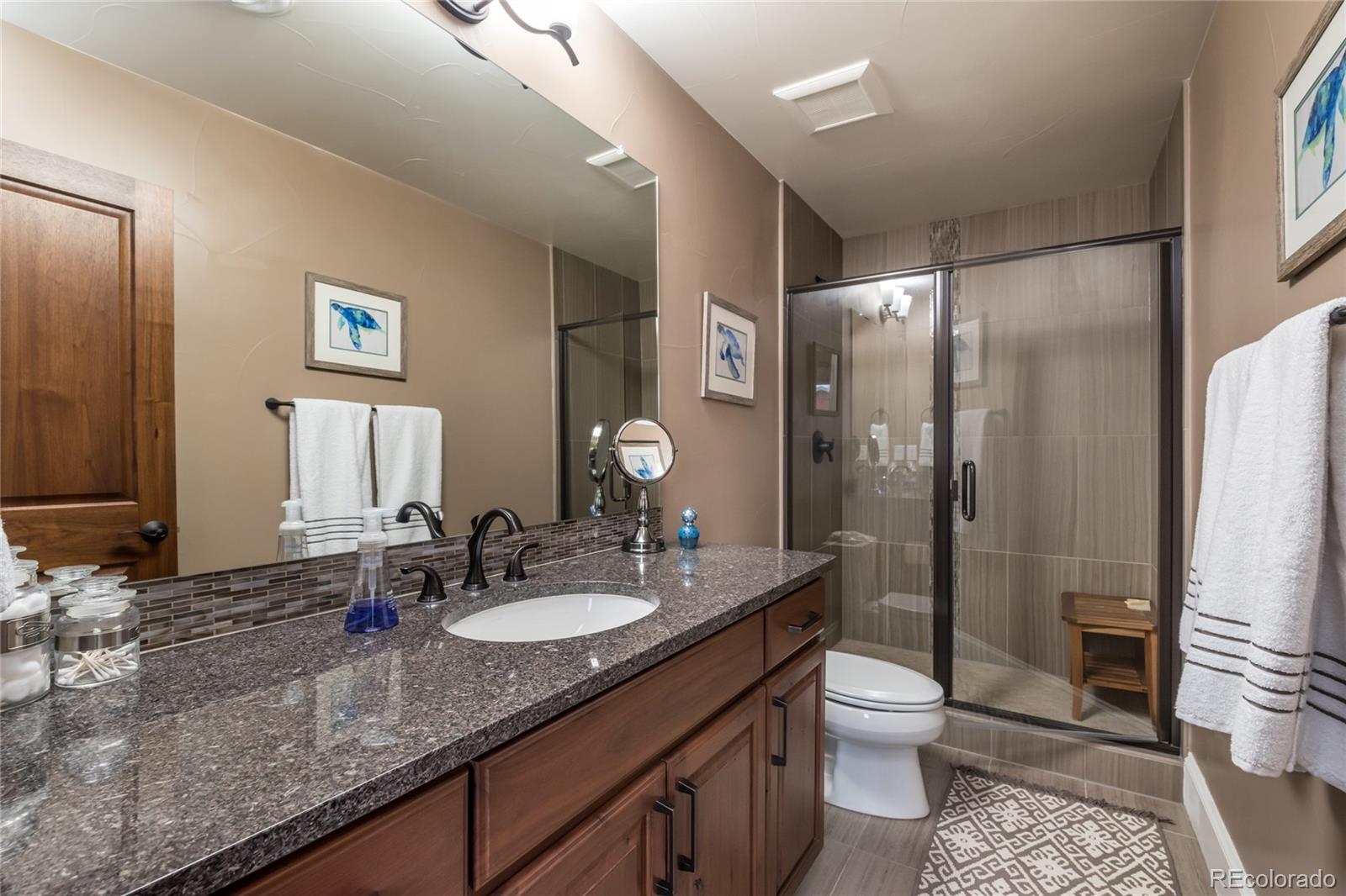 4624 Sunnyside Place Boulder, CO 80301 - Photo 33 of 40 a bathroom with a granite countertop sink toilet and shower