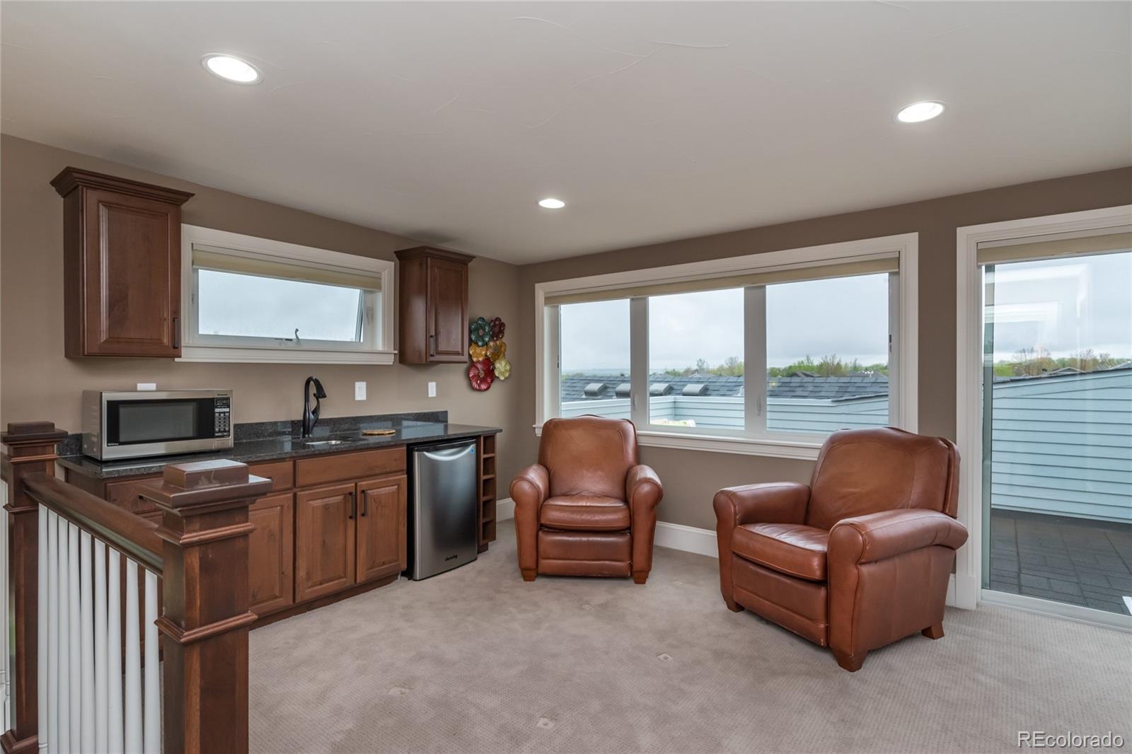 4624 Sunnyside Place Boulder, CO 80301 - Photo 34 of 40 a living room with furniture and a open kitchen view