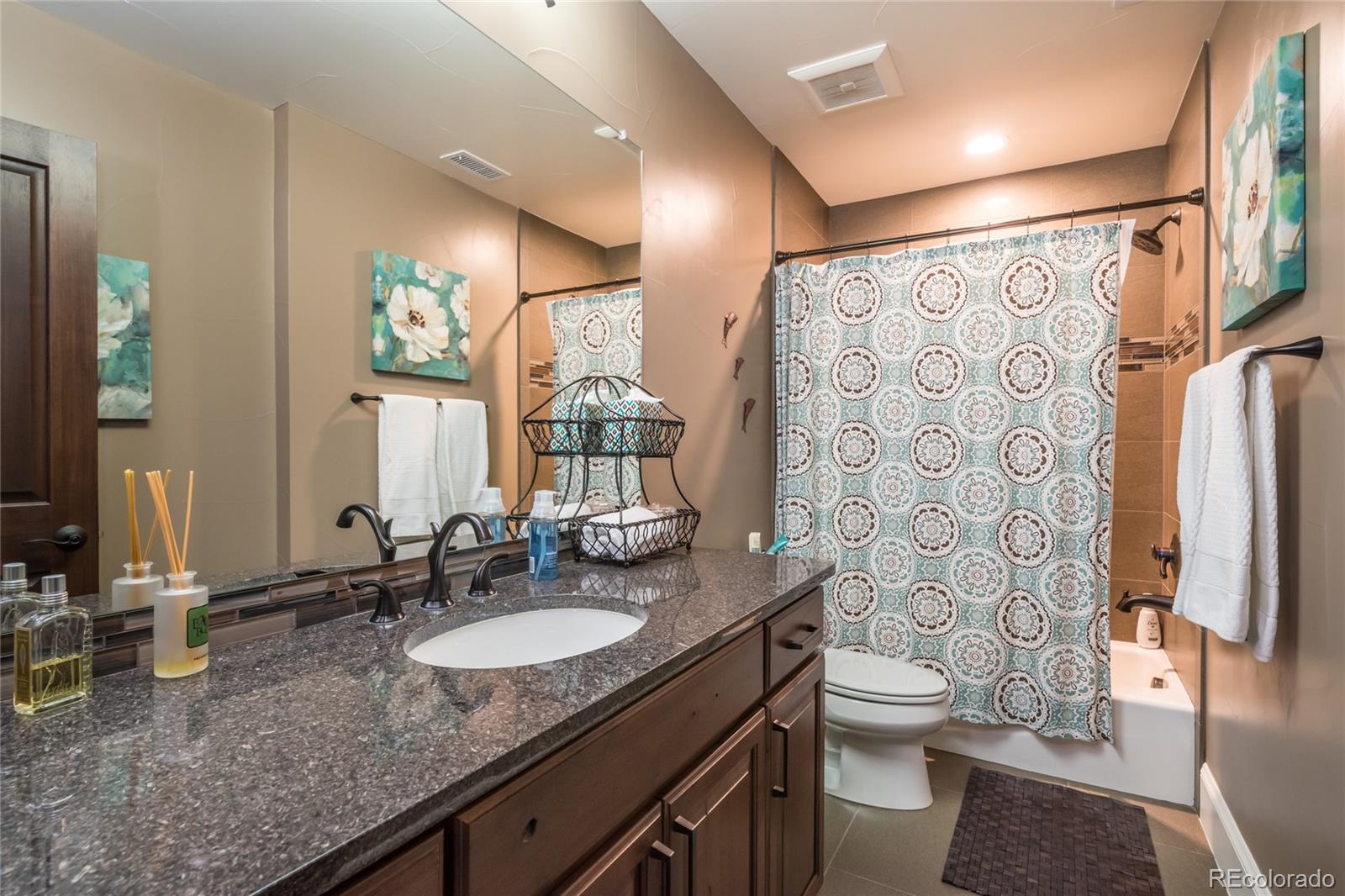 4624 Sunnyside Place Boulder, CO 80301 - Photo 39 of 40 a bathroom with a granite countertop sink toilet and shower