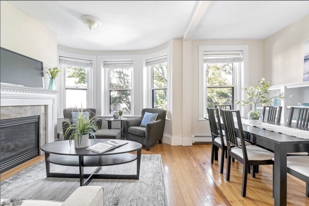 120 Brook Street, Unit 3 Brookline, MA 02445 - Photo 7 of 10 a living room with furniture dining table and a fireplace