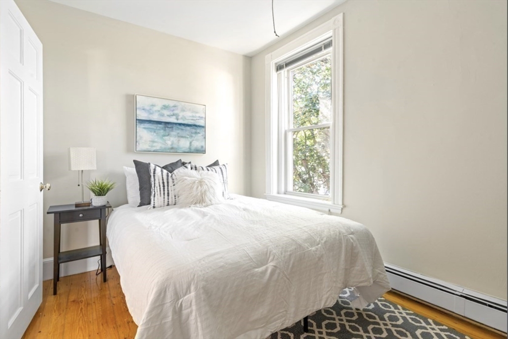 120 Brook Street, Unit 3 Brookline, MA 02445 - Photo 10 of 10 a bedroom with a bed and a lamp next to a window