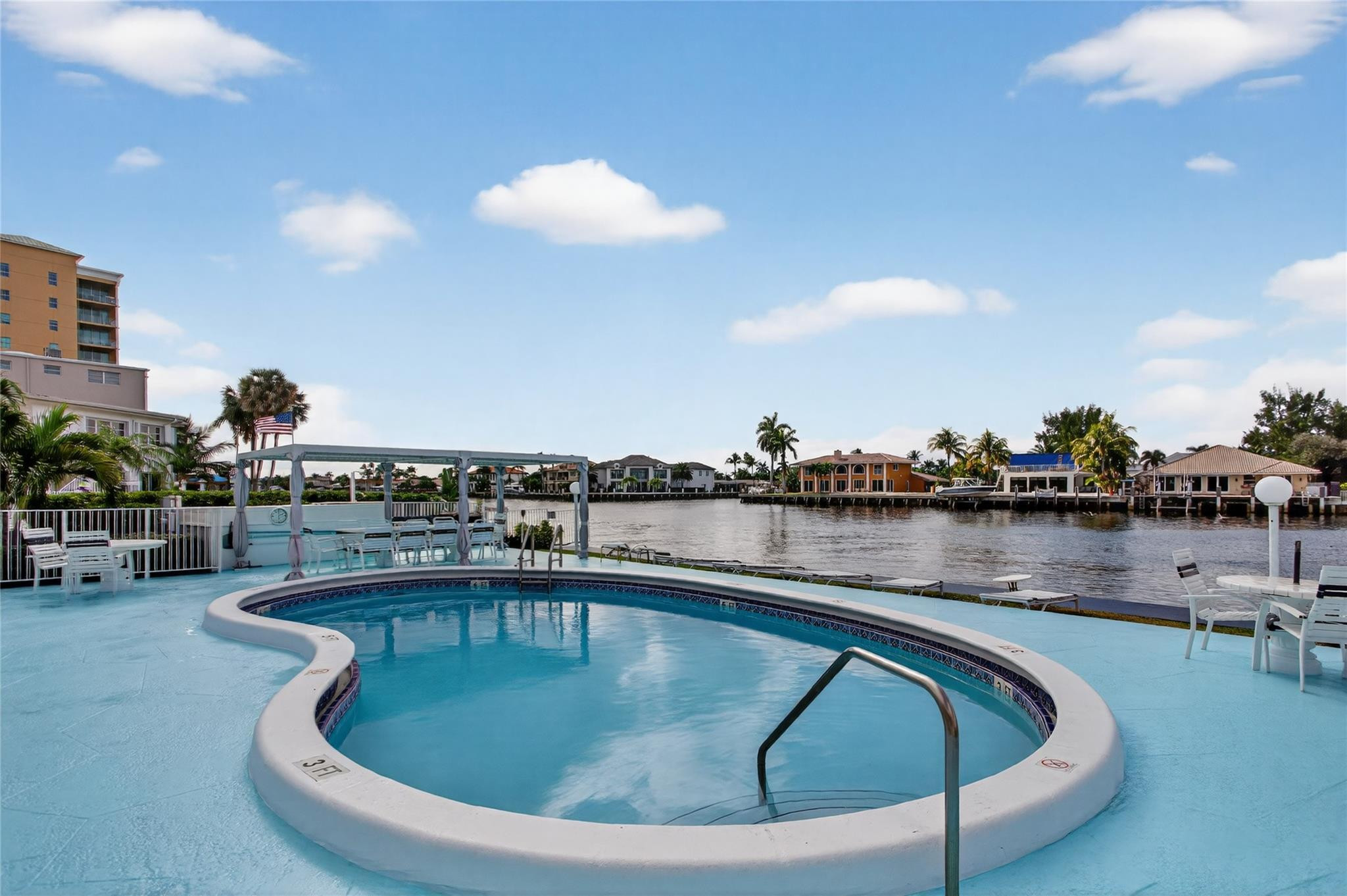 1001 North Riverside Drive, Unit 305 Pompano Beach, FL 33062 - Photo 29 of 44 a view of a swimming pool with outdoor seating