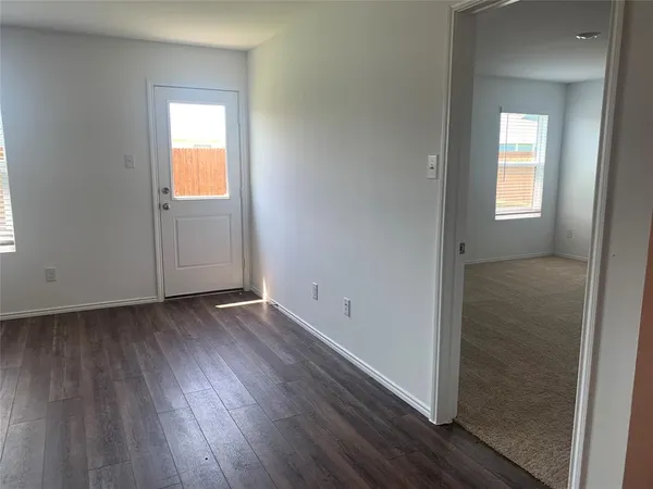 an empty room with wooden floor and closet