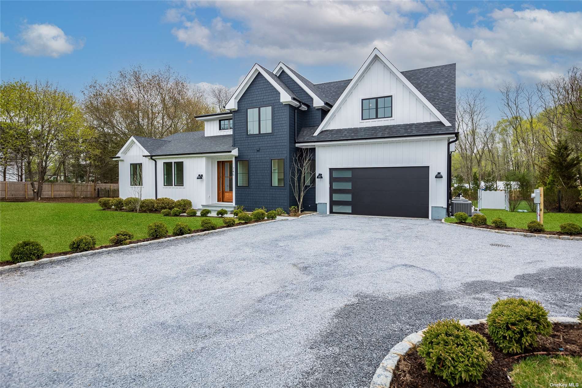 245 Rachels Road Mattituck, NY 11952 - Photo 1 of 1 a front view of a house with a yard and garage