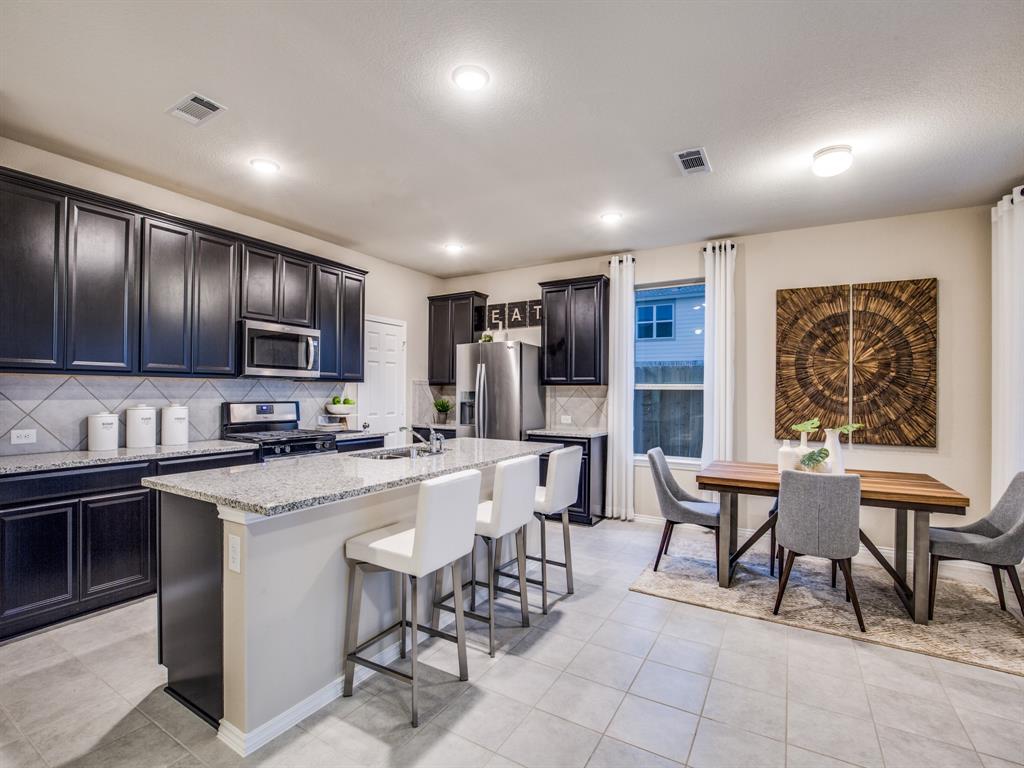 16016 Isles Drive Haslet, TX 76052 - Photo 3 of 8 Abundant cabinet space in kitchen *Model Representation*