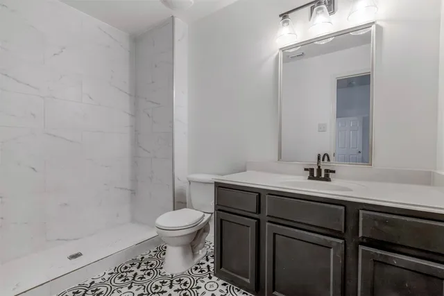 a kitchen with stainless steel appliances kitchen island a table chairs in it and wooden floors