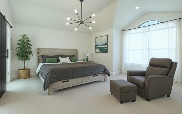 a bedroom with a bed and chair