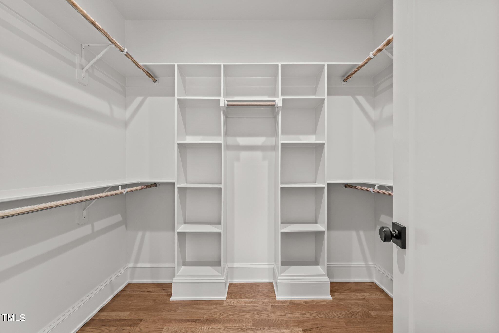 805 Tower Street, Unit 102 Raleigh, NC 27607 - Photo 19 of 36 a view of walk in closet with empty racks