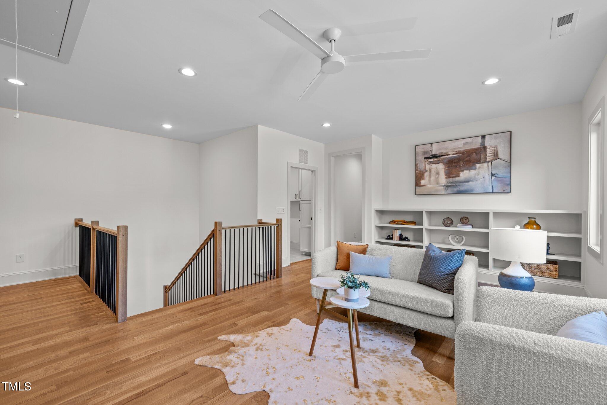 805 Tower Street, Unit 102 Raleigh, NC 27607 - Photo 21 of 36 a living room with furniture and wooden floor