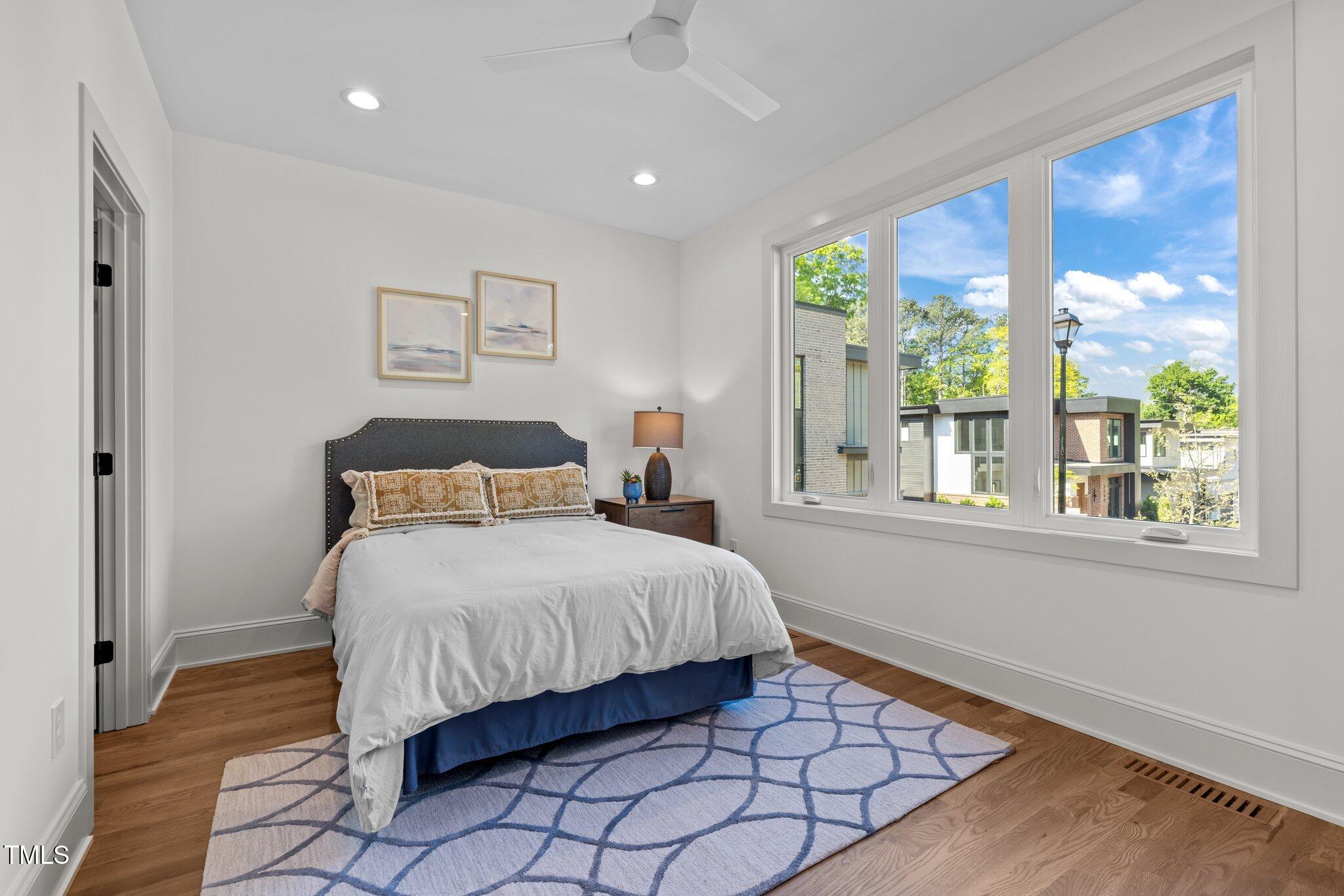 805 Tower Street, Unit 102 Raleigh, NC 27607 - Photo 24 of 36 a bedroom with a bed and window