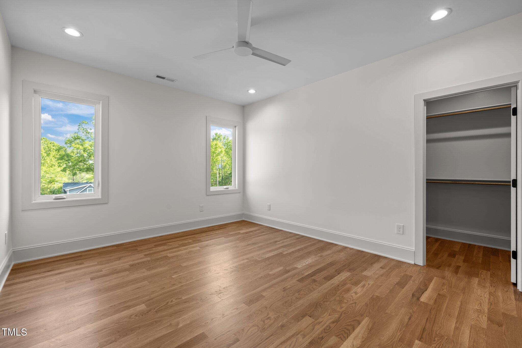 805 Tower Street, Unit 102 Raleigh, NC 27607 - Photo 28 of 36 an empty room with windows and natural light