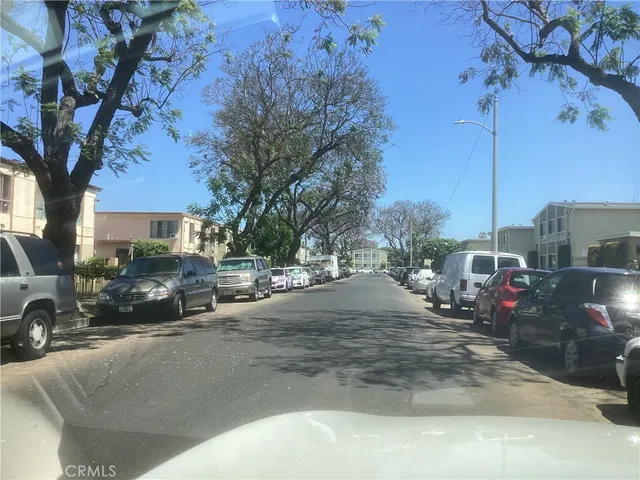 a view of street with parked cars