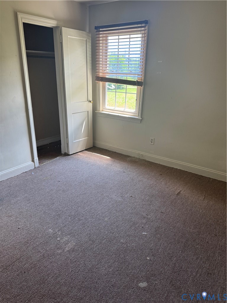 950 Christ Church Road Weems, VA 22576 - Photo 2 of 7 Unfurnished bedroom with carpet floors and a close