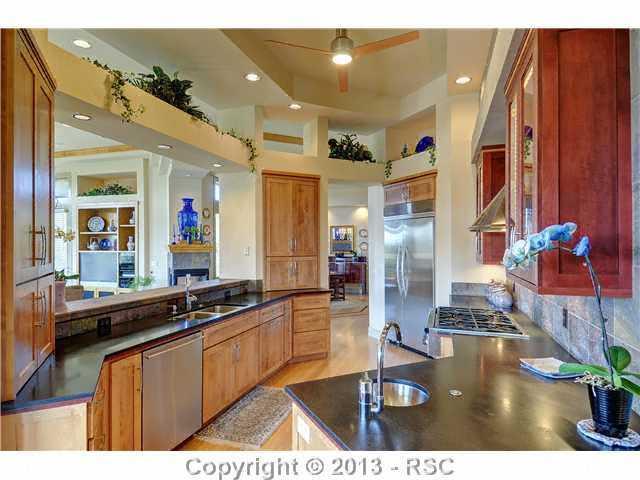 4265 Hidden Rock Road Colorado Springs, CO 80908 - Photo 9 of 25 Gourmet Kitchen w/ Black Granite Counter Tops, Slate Backsplash, 2 Sinks, Stainless Steel Appliances, Cherry Cabinets, Walk-in Pantry & Counter Bar