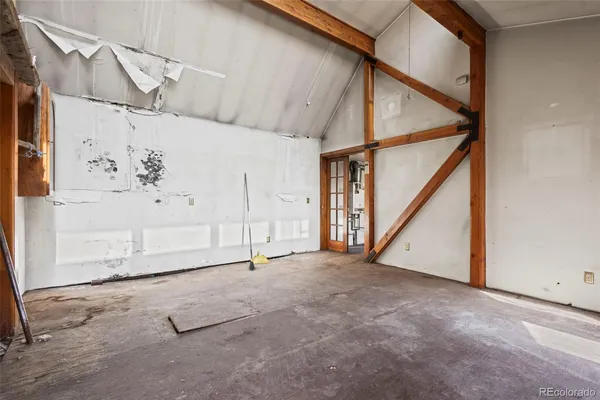 a view of staircase with lots of frames on wall and a large window