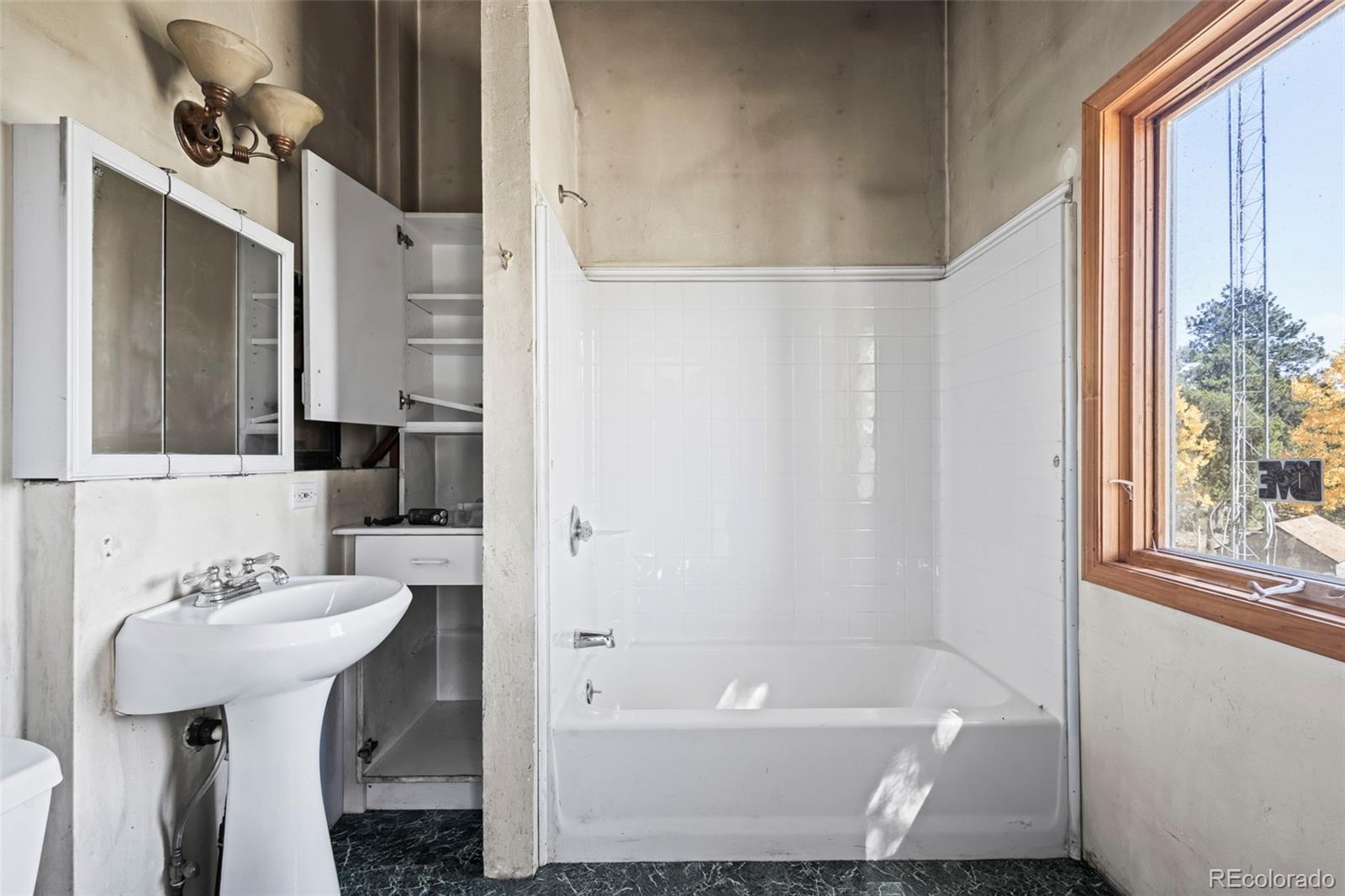 719 Miners Candle Road Idaho Springs, CO 80452 - Photo 18 of 50 a bathroom with a sink toilet and shower