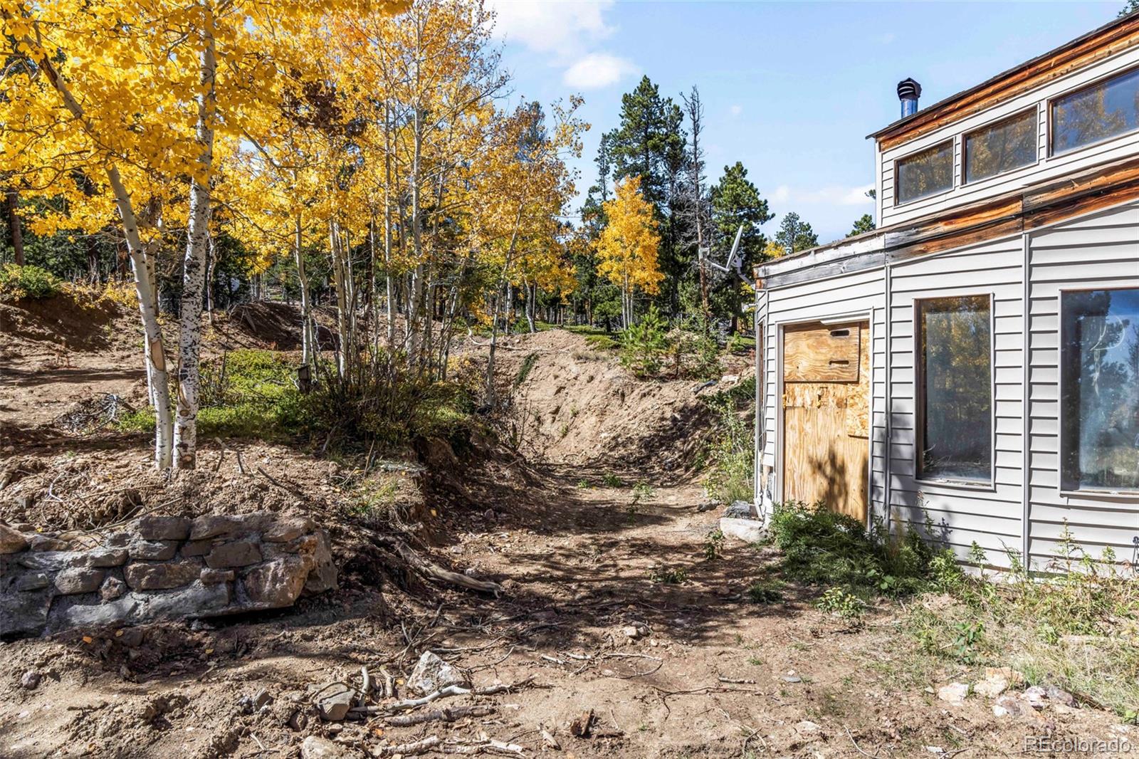 719 Miners Candle Road Idaho Springs, CO 80452 - Photo 37 of 50 a view of a house with a yard