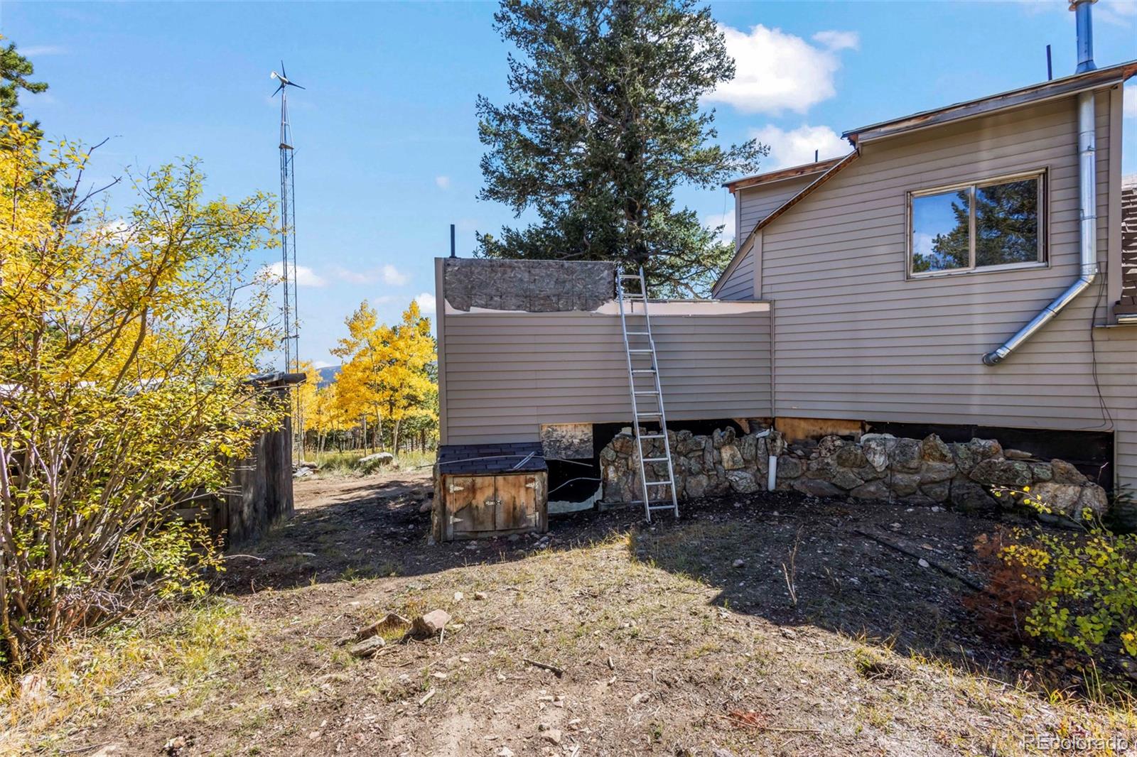 719 Miners Candle Road Idaho Springs, CO 80452 - Photo 6 of 50 a front view of a house with garden