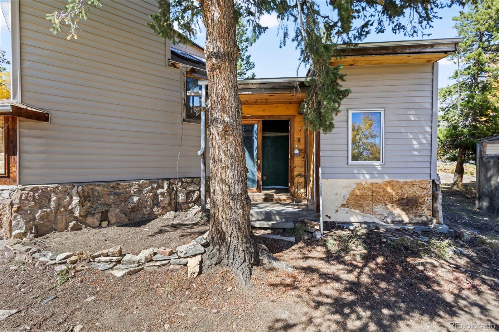 719 Miners Candle Road Idaho Springs, CO 80452 - Photo 8 of 50 a view of a house with a yard