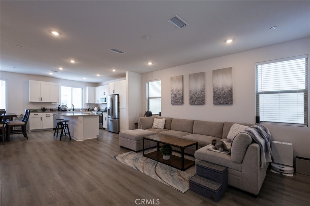 a living room with furniture and kitchen view
