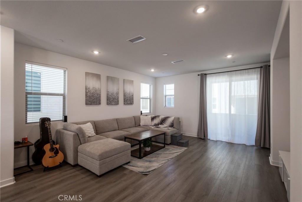 2640 Sprout Lane, Unit 104 Corona, CA 92883 - Photo 3 of 20 a living room with furniture and a wooden floor