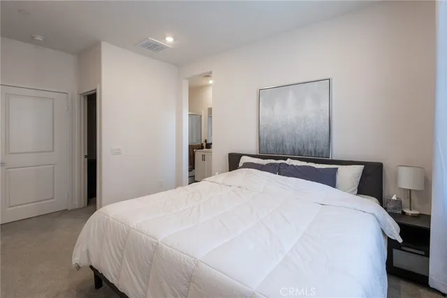 a large bed sitting in a bedroom and closet