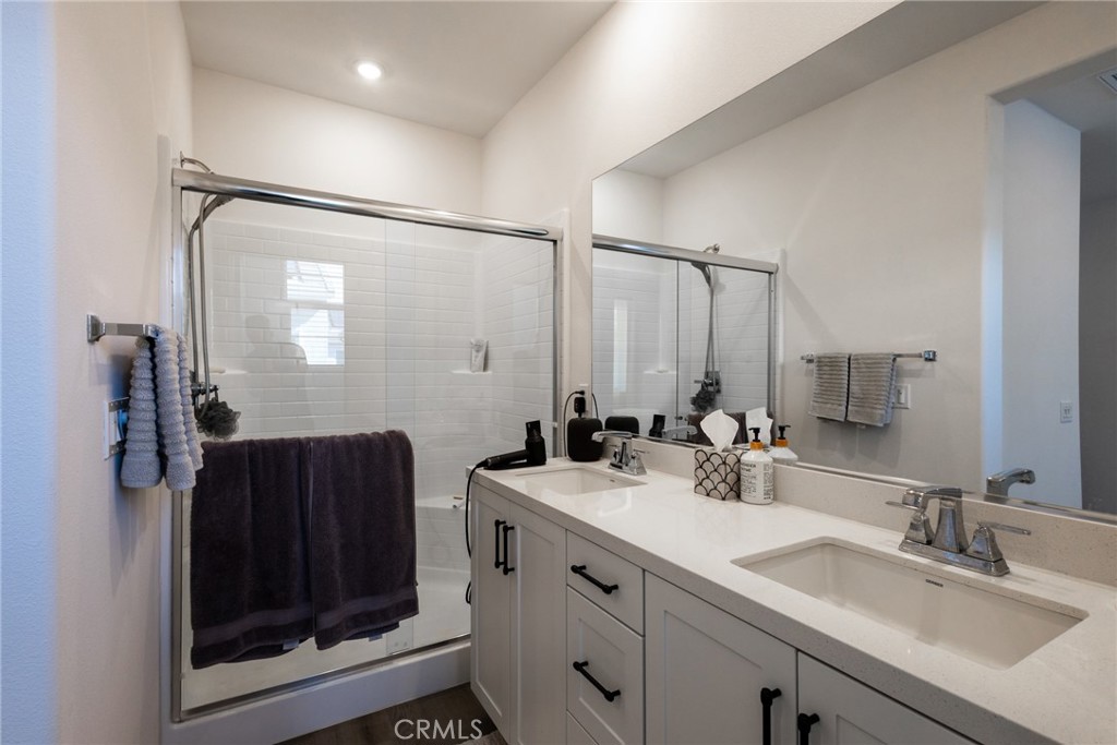 2640 Sprout Lane, Unit 104 Corona, CA 92883 - Photo 9 of 20 a bathroom with a sink double vanity and a mirror