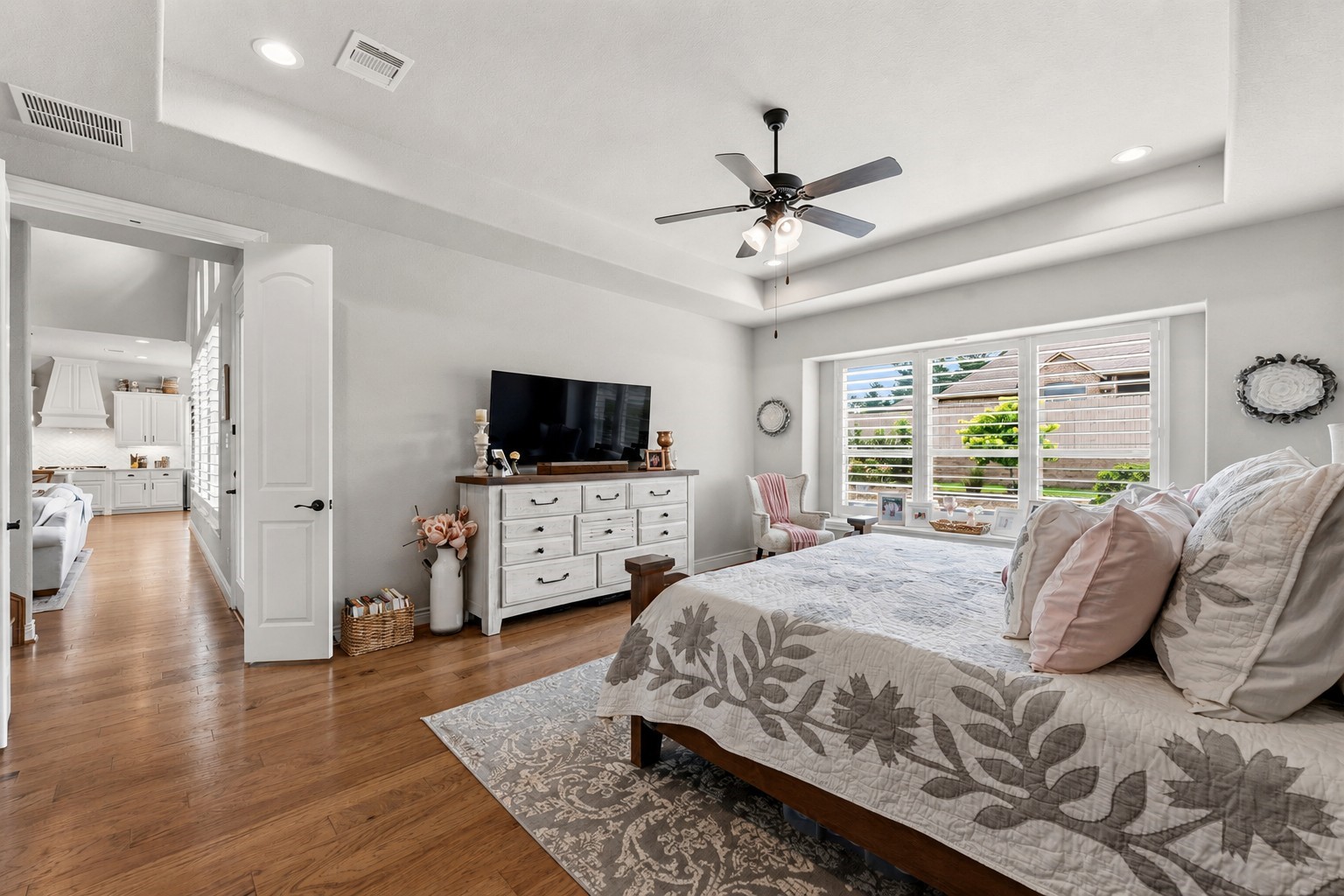 14012 Beartooth Bend Trail Conroe, TX 77384 - Photo 20 of 50 The spacious primary suite offers tranquil views of the backyard and pool, creating a private retreat. With ample room for virtually any furniture arrangement, the space combines comfort, flexibility, and relaxation.
