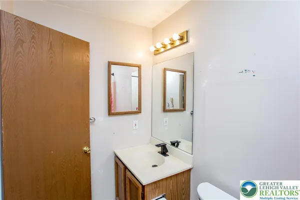 a bathroom with a sink mirror and vanity