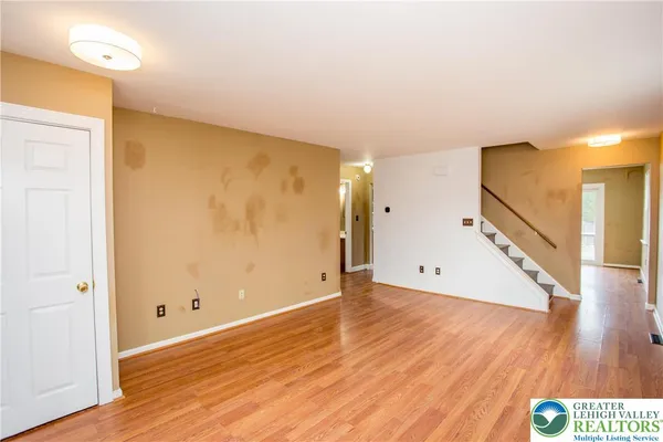 a view of an empty room with wooden floor