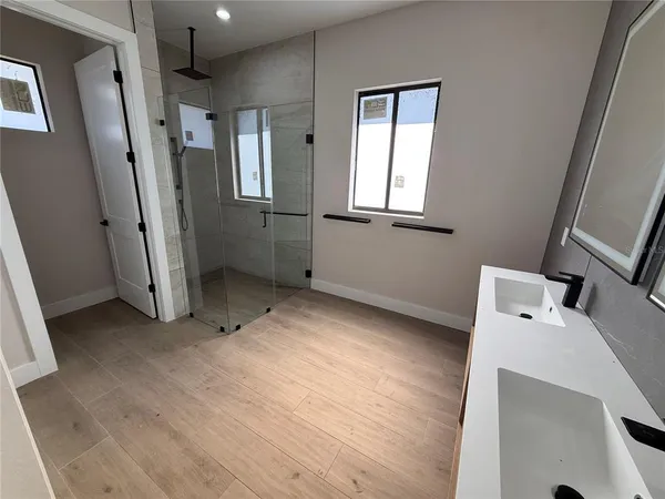 a bathroom with a sink a toilet and shower