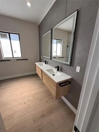 a spacious bathroom with a double vanity sink and a mirror