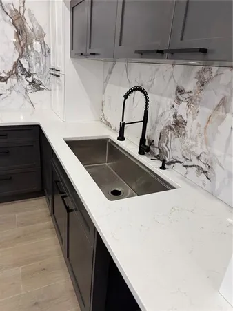 a kitchen with a sink and cabinets