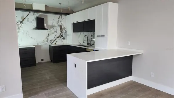 a kitchen with stainless steel appliances a microwave stove and cabinets