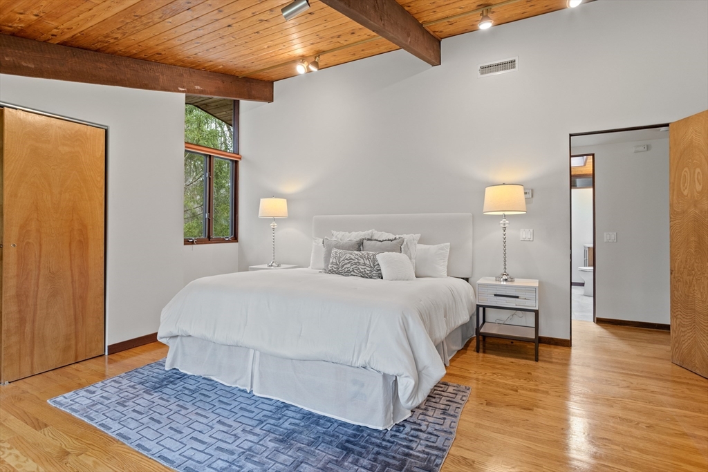 69 Long Ridge Road Carlisle, MA 01741 - Photo 17 of 42 a bedroom with a bed rug and wooden floor