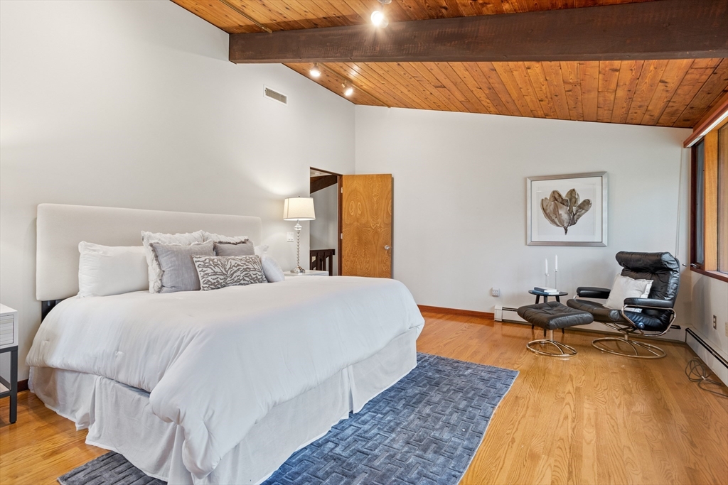 69 Long Ridge Road Carlisle, MA 01741 - Photo 18 of 42 a bedroom with a bed and wooden floor