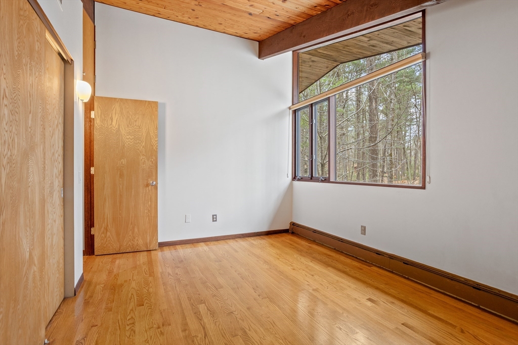 69 Long Ridge Road Carlisle, MA 01741 - Photo 21 of 42 a view of an empty room with wooden floor and a window