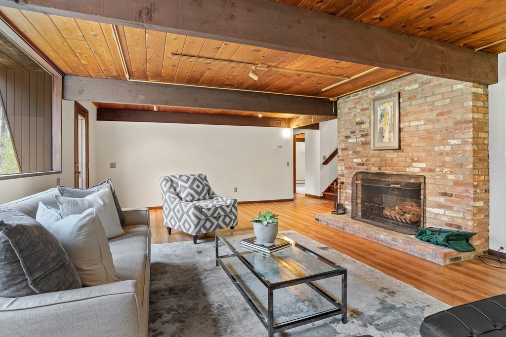 69 Long Ridge Road Carlisle, MA 01741 - Photo 27 of 42 a living room with furniture and a fireplace