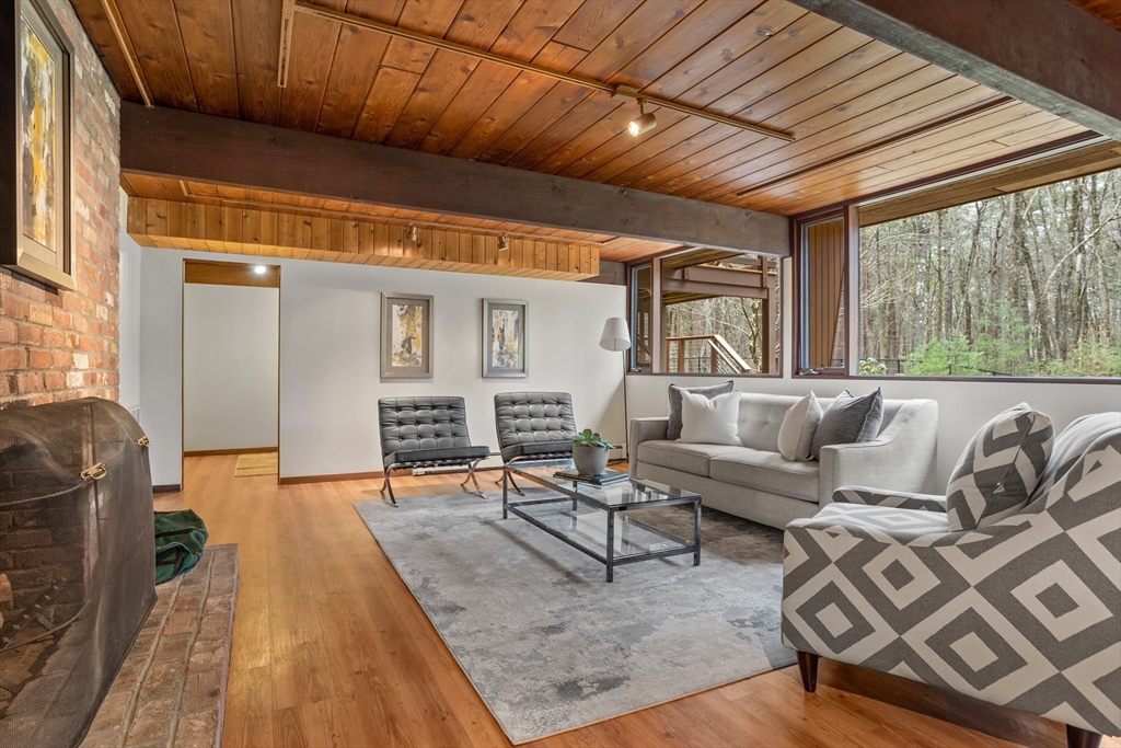 69 Long Ridge Road Carlisle, MA 01741 - Photo 28 of 42 a living room with furniture a fireplace and wooden floor