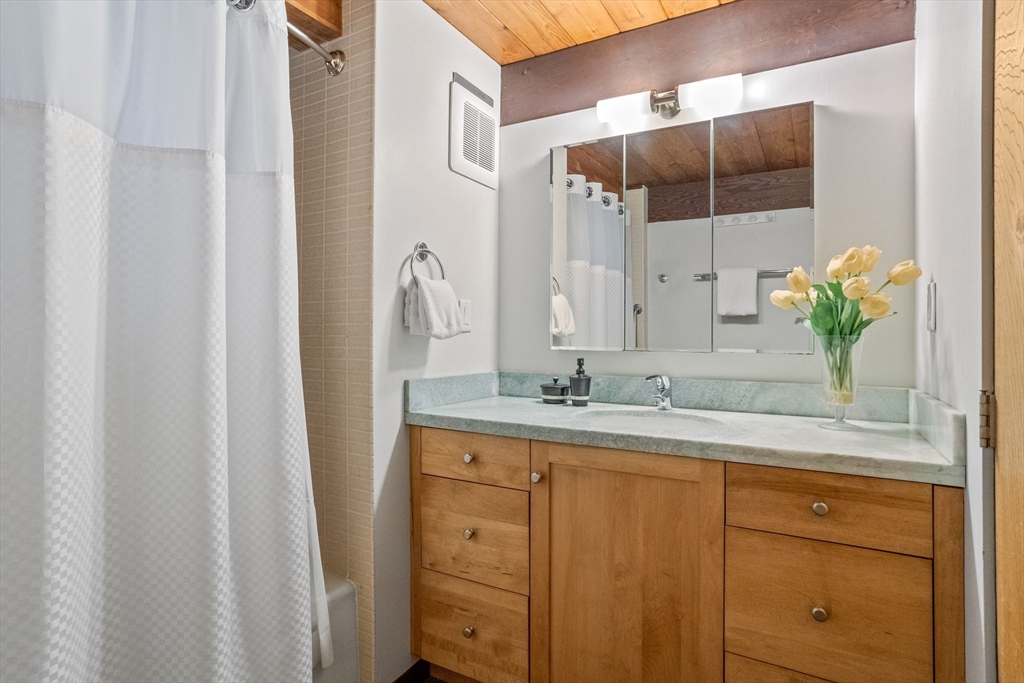 69 Long Ridge Road Carlisle, MA 01741 - Photo 33 of 42 a bathroom with a granite countertop sink and a mirror