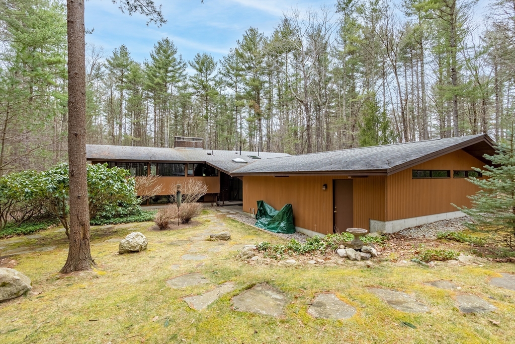 69 Long Ridge Road Carlisle, MA 01741 - Photo 35 of 42 a view of backyard with large trees and wooden fence