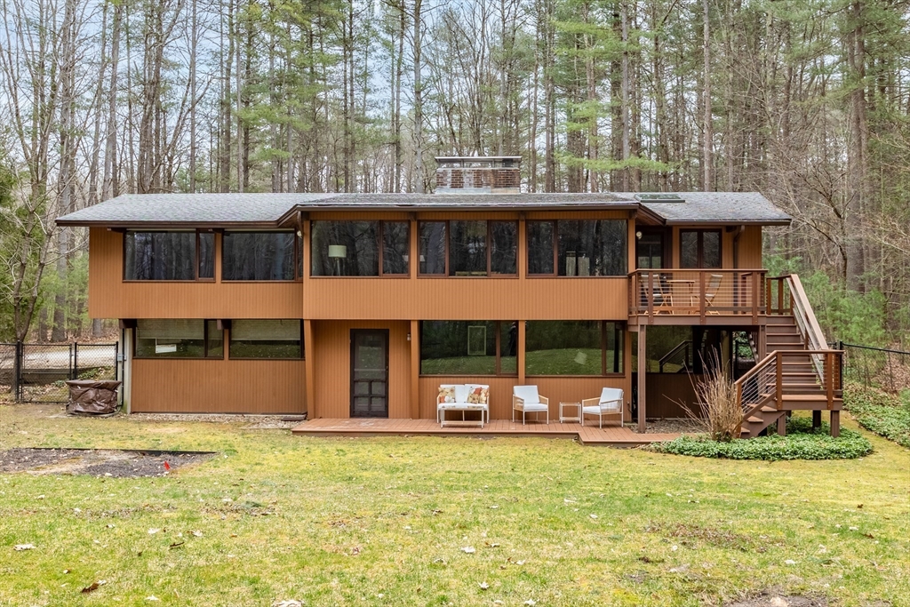 69 Long Ridge Road Carlisle, MA 01741 - Photo 38 of 42 a front view of a house with a garden and trees